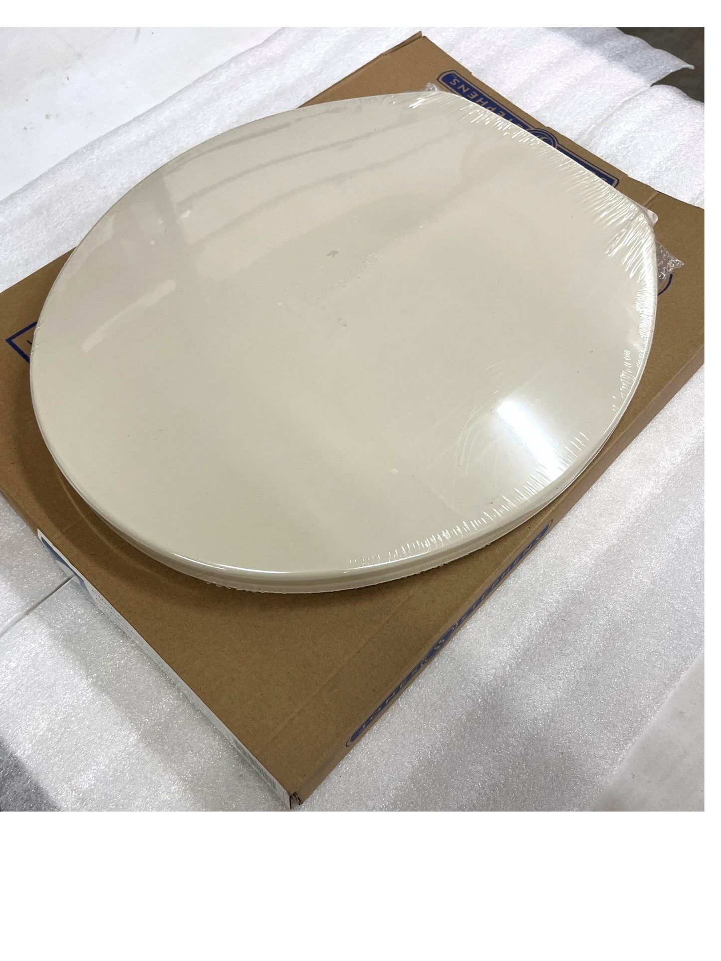 North Country Supply Jones Stephens bone plastic round toilet seat with cover in original packaging.