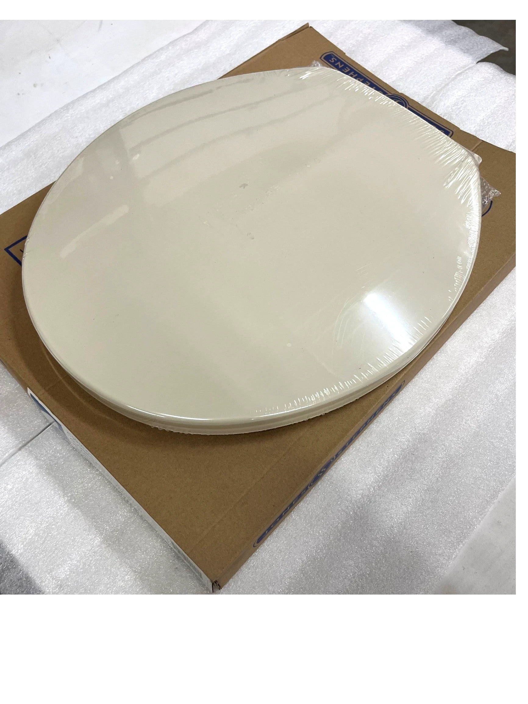 North Country Supply Jones Stephens bone plastic round toilet seat with cover in original packaging.