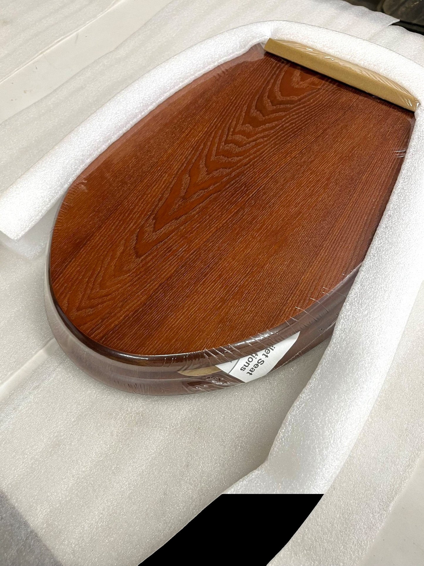 North Country Supply decorative wood toilet seat in cherry finish with brushed nickel hinges, designed for elongated bowls.