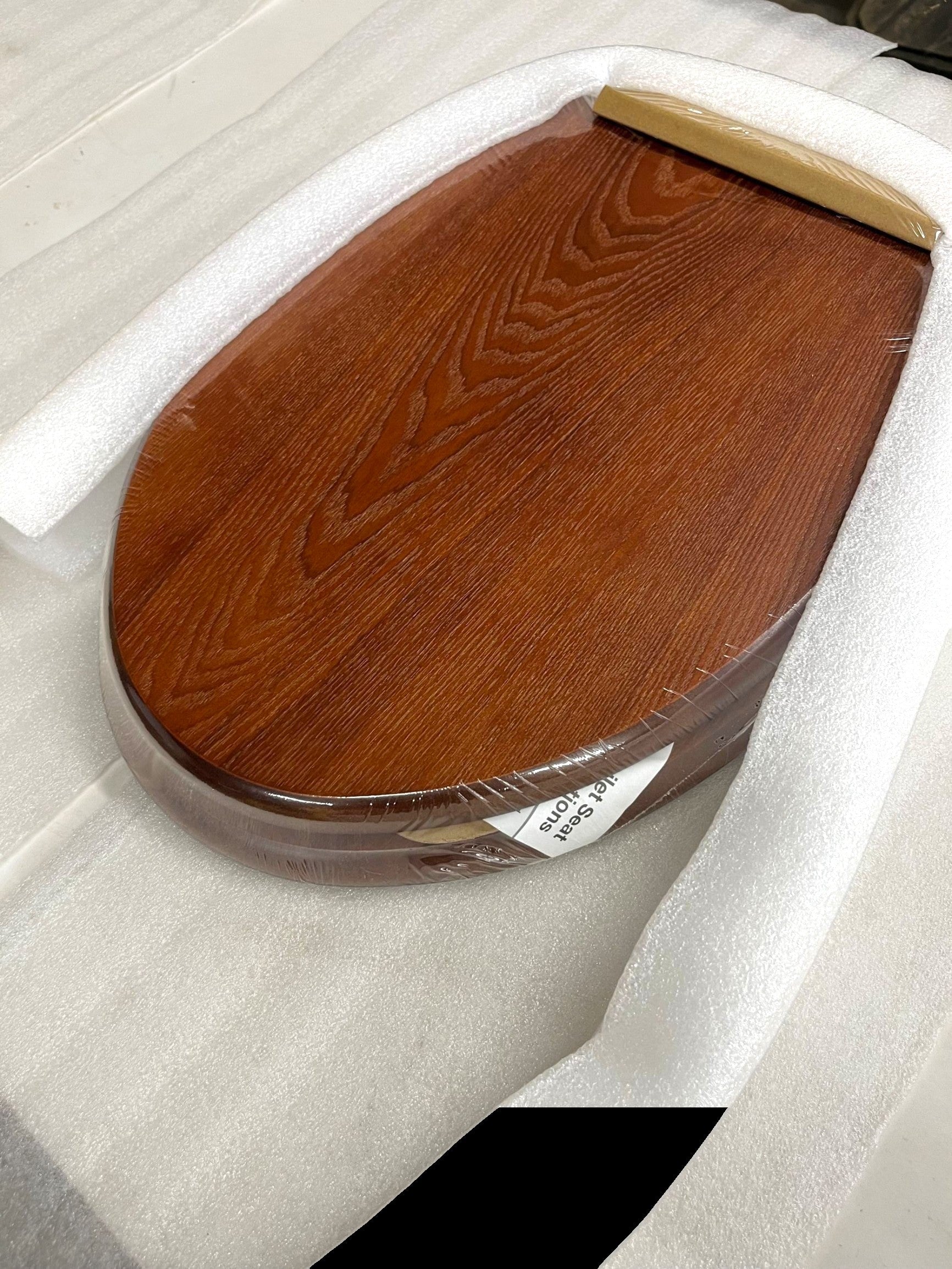 North Country Supply decorative wood toilet seat in cherry finish with brushed nickel hinges, designed for elongated bowls.