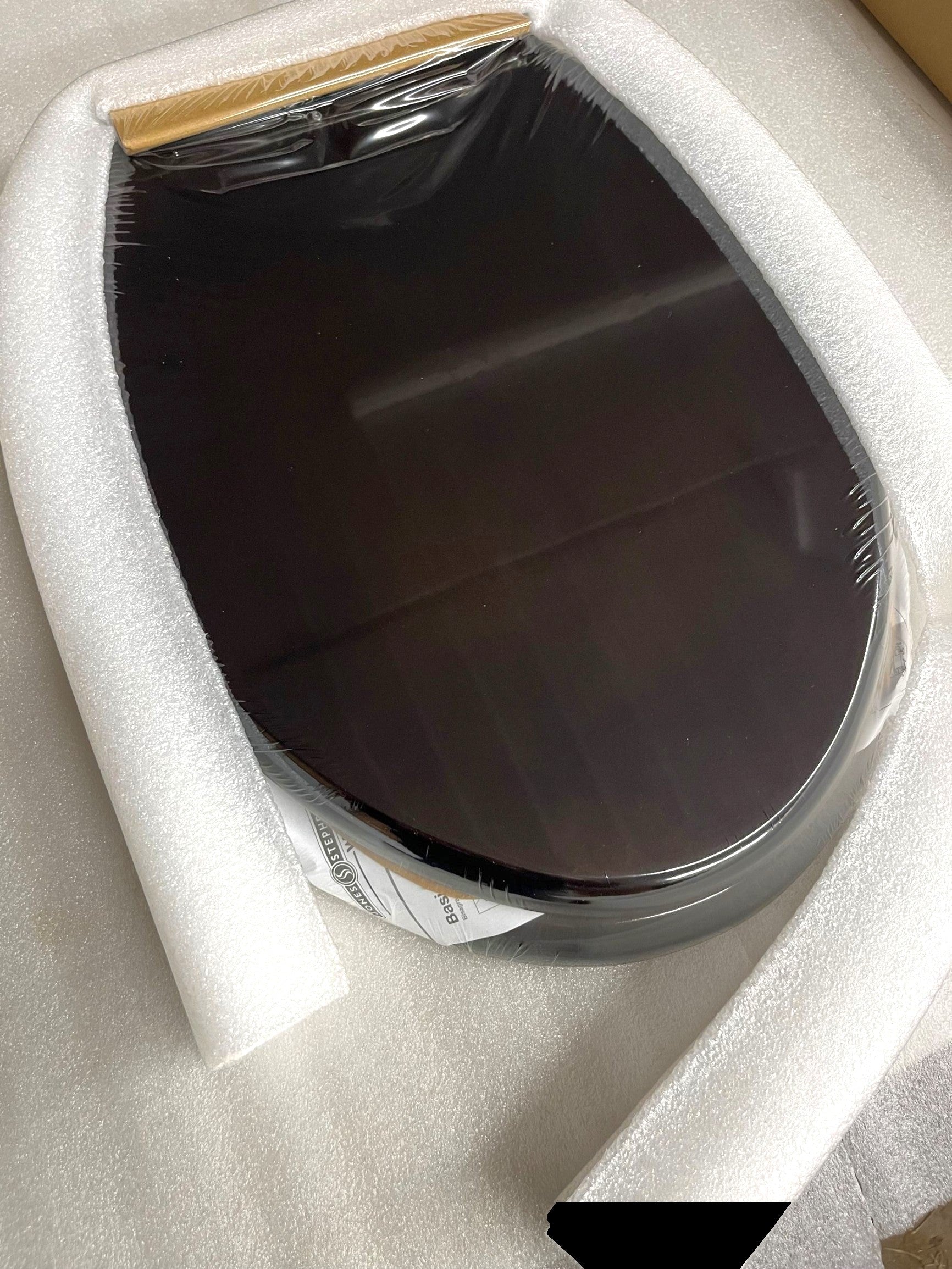 North Country Supply dark brown wooden toilet seat with metal hinges. Oval shape, smooth finish.