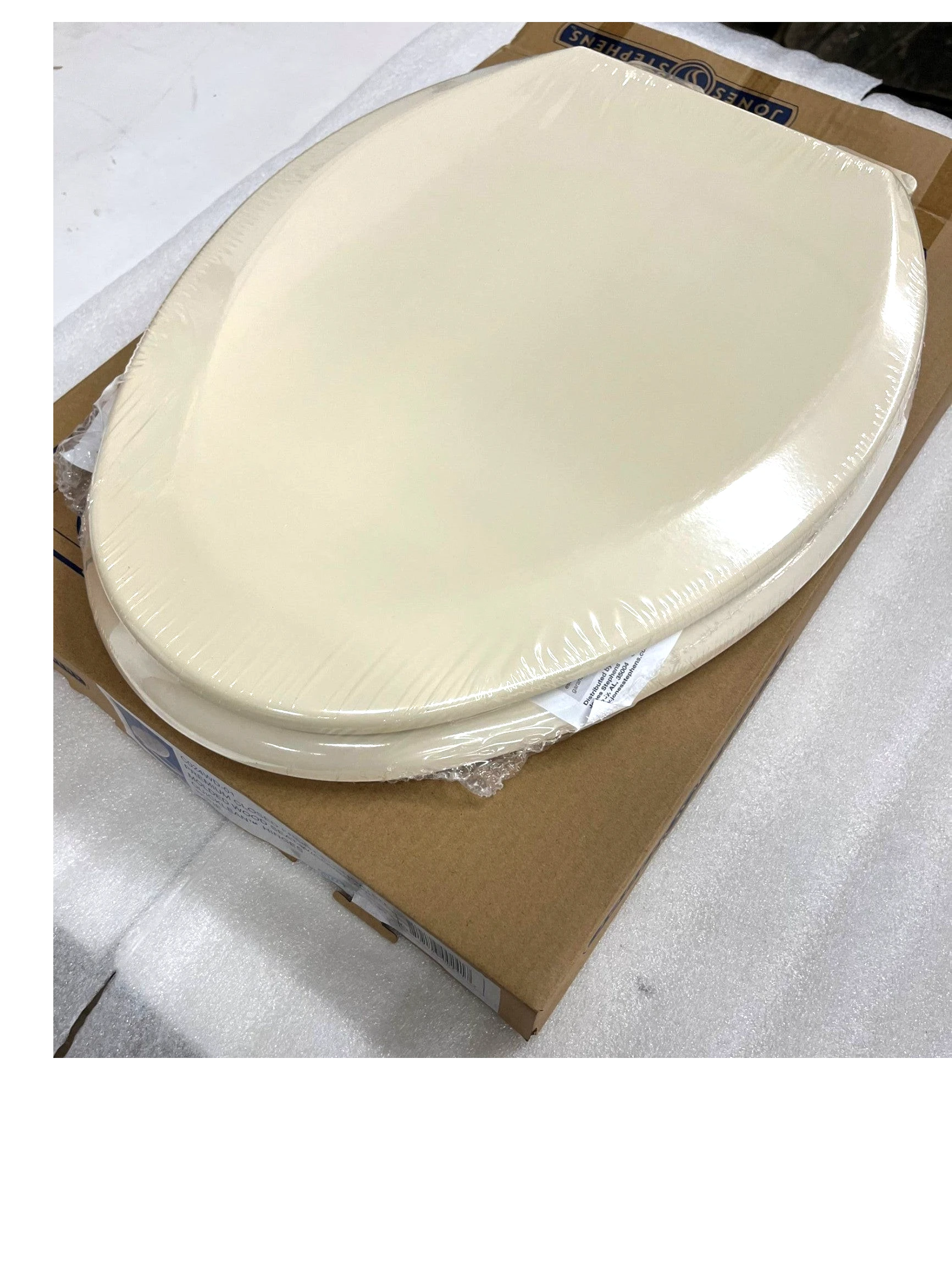 North Country Supply bone elongated molded wood toilet seat with closed front and QuickLean hinges in packaging.