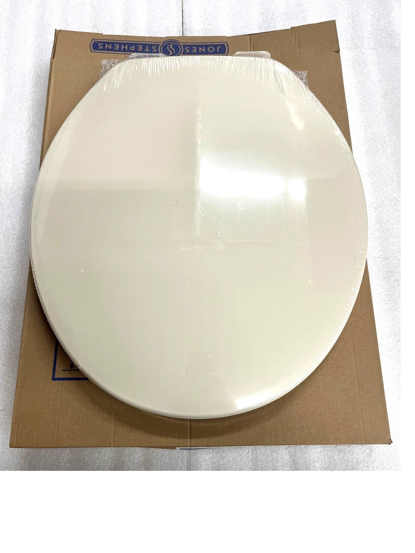 North Country Supply Jones Stephens round plastic toilet seat in bone finish with closed-front cover.